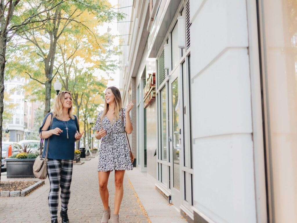 two people talking outside a retail store