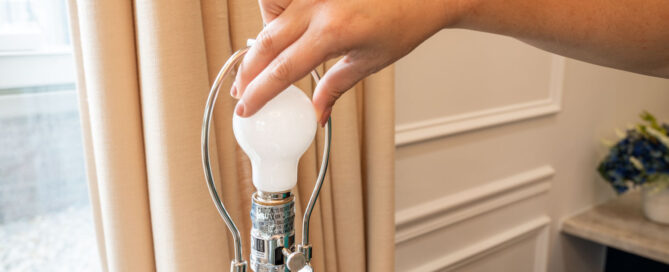 Property manager screwing in a lightbulb